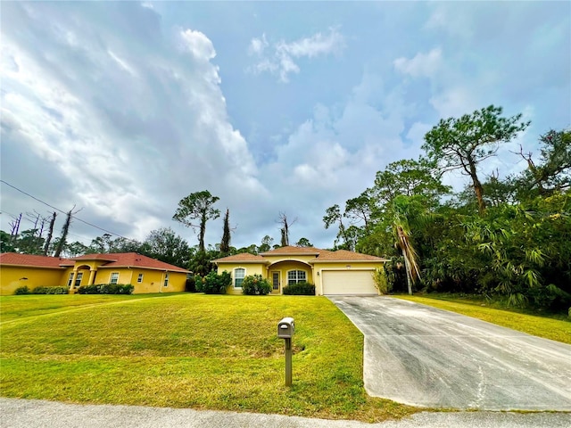 view of front facade with a garage and a front lawn