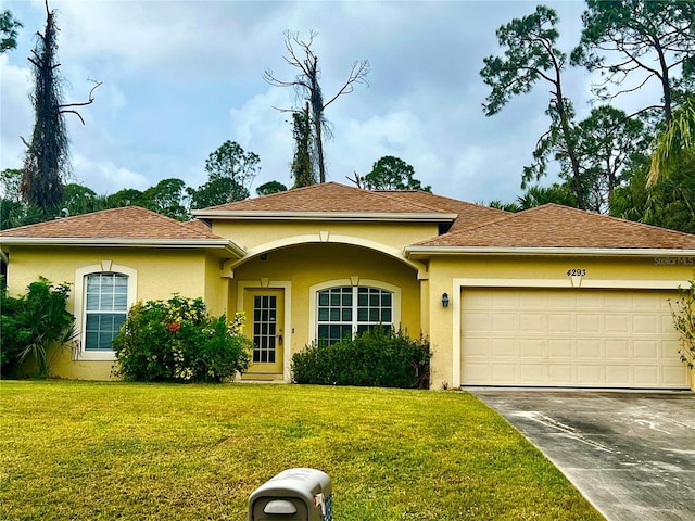 view of front facade with a garage and a front yard