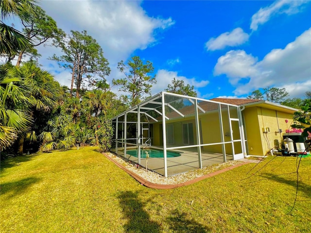 back of property with a patio area, a lanai, and a lawn