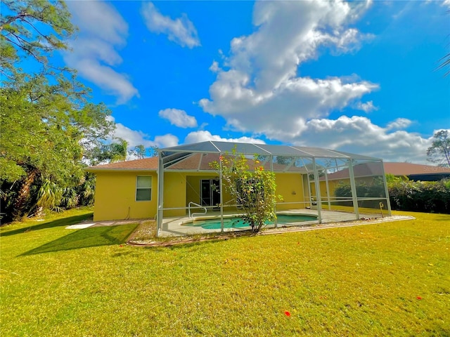 back of house featuring a patio, a lanai, and a yard