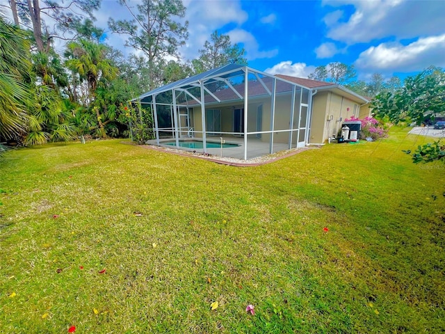 back of house with glass enclosure, a patio area, and a lawn