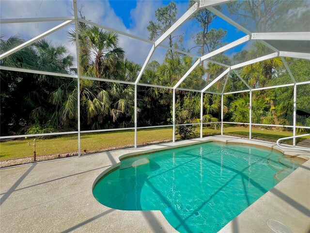 view of pool with a lanai, a yard, and a patio