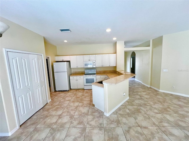 kitchen with white cabinetry, white appliances, kitchen peninsula, and light tile patterned floors