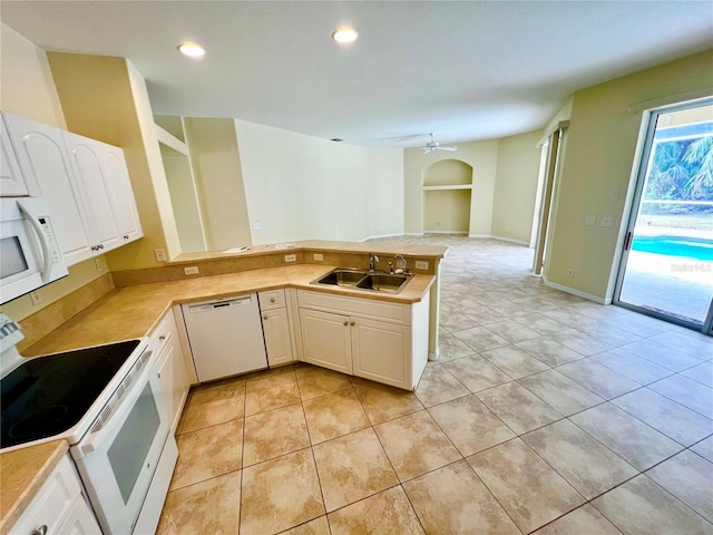 kitchen with white appliances, white cabinetry, sink, kitchen peninsula, and light tile patterned flooring