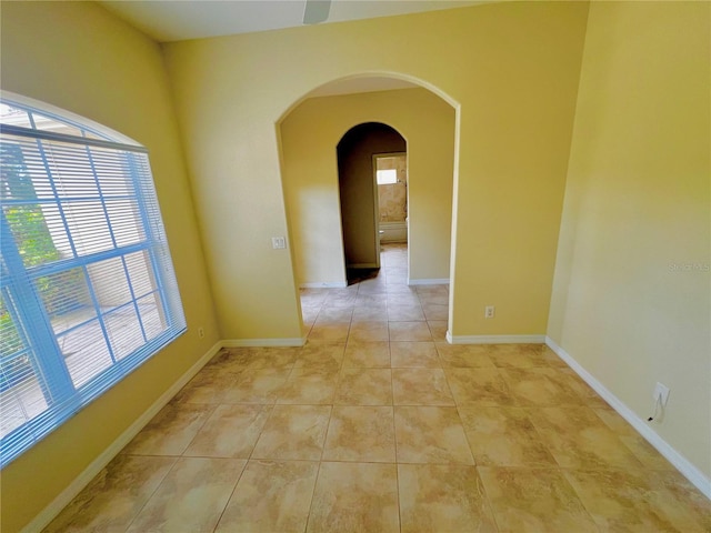 unfurnished room with light tile patterned floors