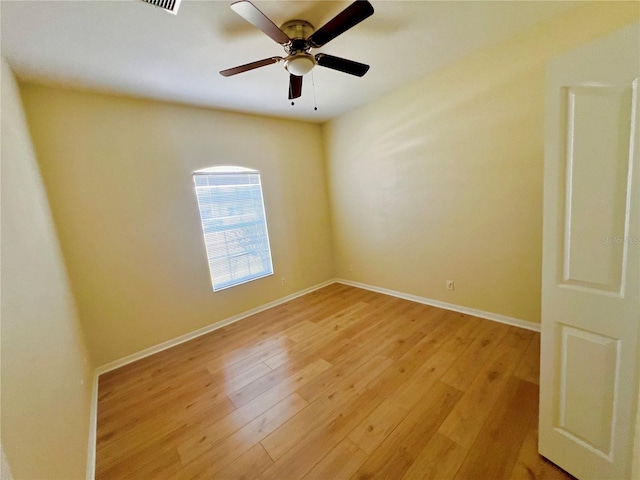 unfurnished room with light wood-type flooring and ceiling fan