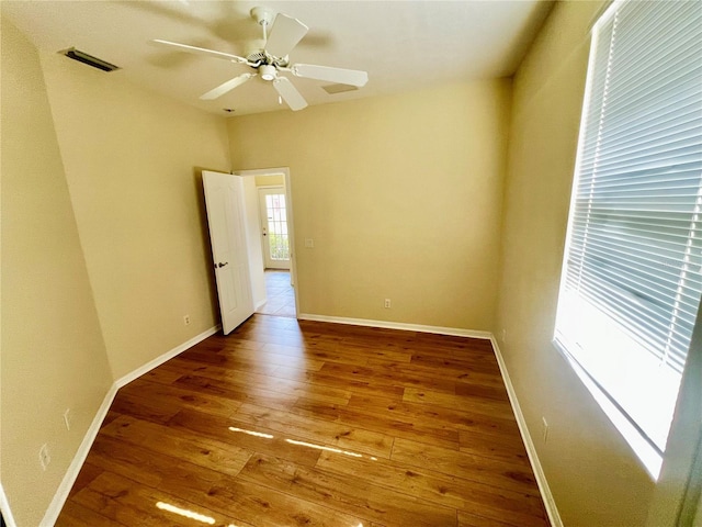 empty room featuring hardwood / wood-style flooring and ceiling fan