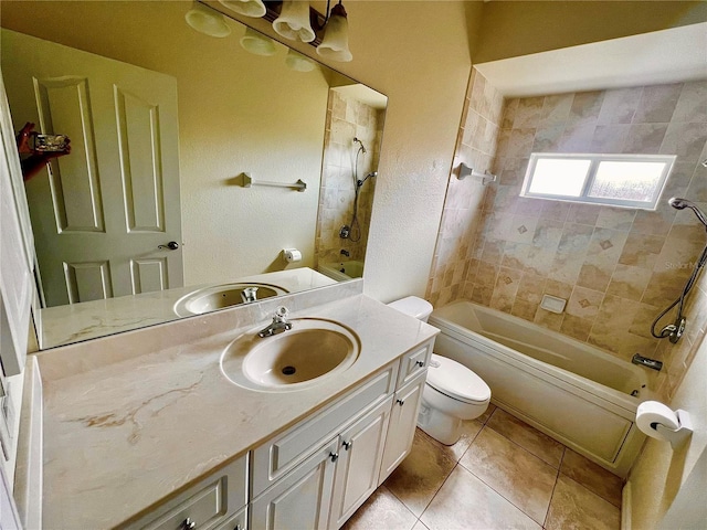 full bathroom featuring vanity, toilet, tile patterned flooring, and tiled shower / bath combo