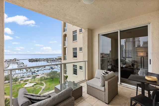 balcony with an outdoor hangout area and a water view