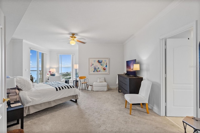 bedroom with ceiling fan, access to exterior, light colored carpet, and crown molding