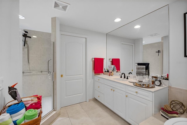 bathroom featuring tile patterned flooring, vanity, and an enclosed shower