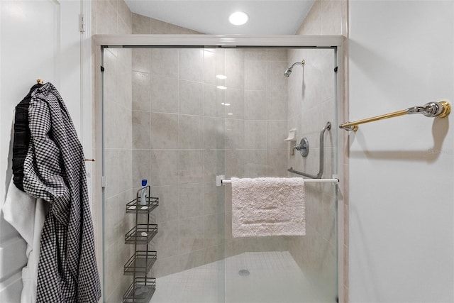 bathroom featuring a shower with shower door