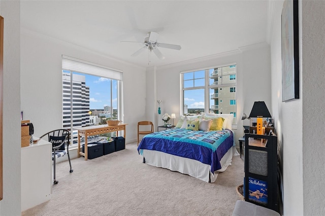 bedroom with carpet flooring, ceiling fan, and crown molding