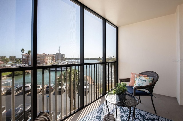 sunroom featuring plenty of natural light and a water view