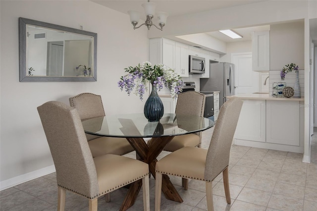 dining space featuring light tile patterned floors, a notable chandelier, and sink