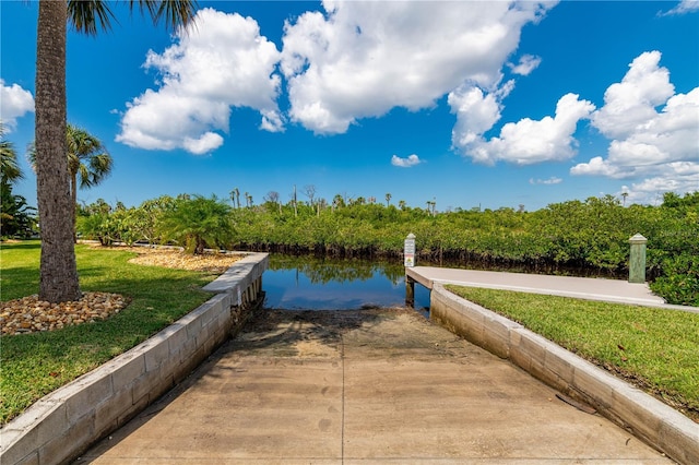 view of home's community featuring a water view and a yard