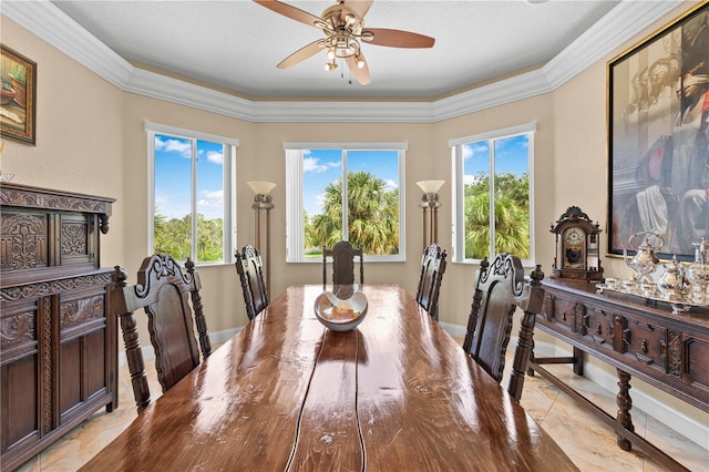 dining space with crown molding and ceiling fan