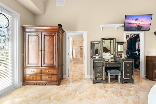 bedroom featuring a spacious closet and a closet