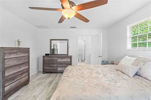 bedroom featuring ensuite bath, light hardwood / wood-style floors, and ceiling fan