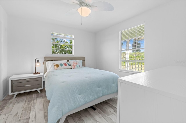 bedroom with ceiling fan and light hardwood / wood-style flooring