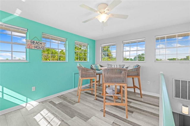 sunroom / solarium with plenty of natural light and ceiling fan