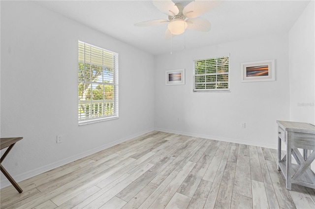 spare room featuring light hardwood / wood-style floors and ceiling fan