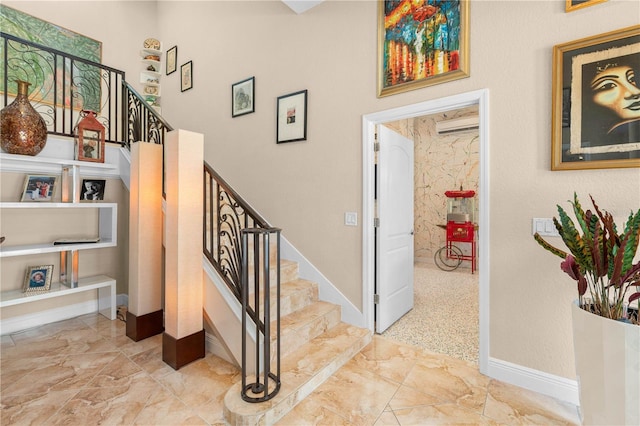 stairway with baseboards and marble finish floor
