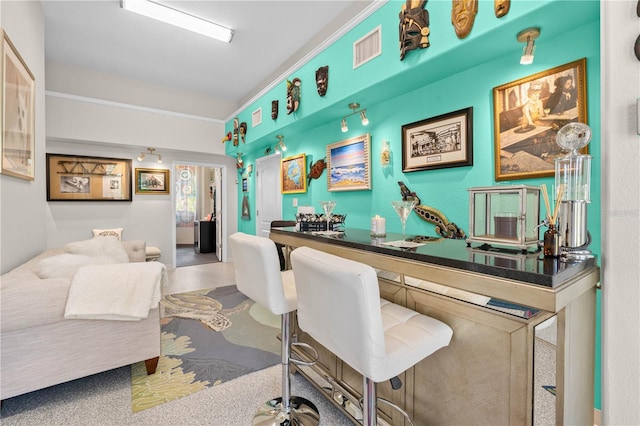 home office featuring visible vents and bar area