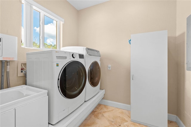 laundry room with baseboards, laundry area, and washer and clothes dryer