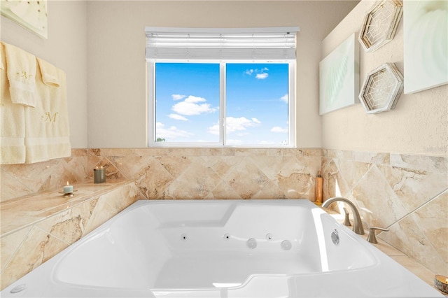full bath featuring a healthy amount of sunlight and a tub with jets
