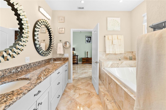 full bathroom with a sink, double vanity, marble finish floor, visible vents, and a garden tub