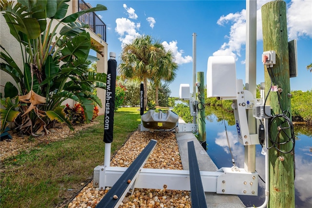 view of property's community with boat lift and a dock