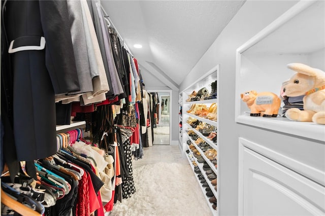 walk in closet with vaulted ceiling