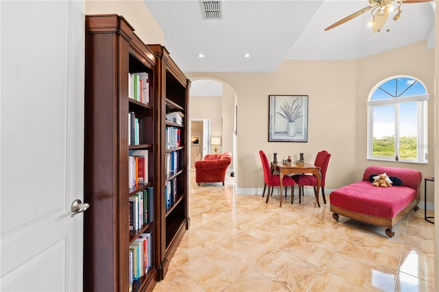 sitting room with visible vents, marble finish floor, baseboards, ceiling fan, and arched walkways