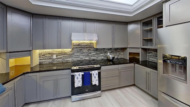 kitchen featuring appliances with stainless steel finishes, gray cabinetry, and a tray ceiling