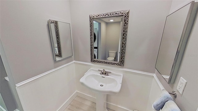 bathroom featuring sink, toilet, and tile patterned flooring