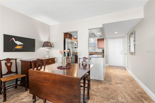 dining area featuring a textured ceiling