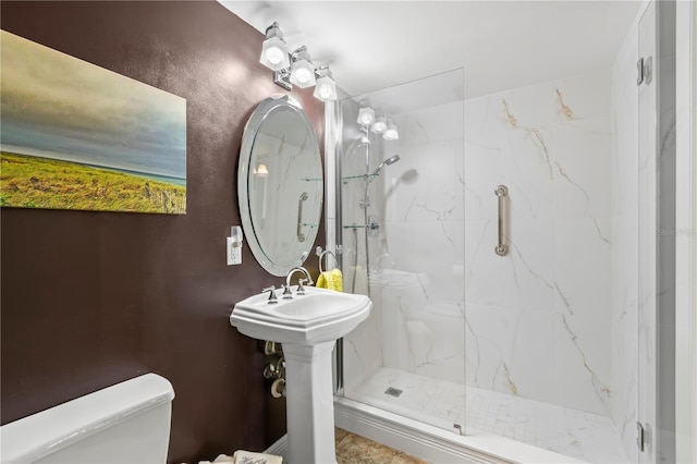 bathroom featuring toilet and an enclosed shower