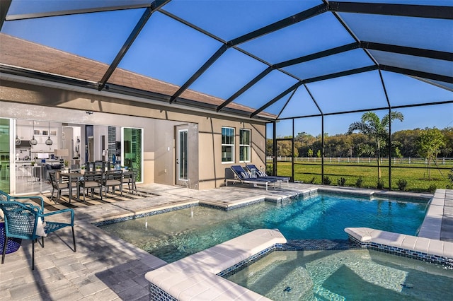 view of swimming pool featuring glass enclosure, an in ground hot tub, a patio area, and pool water feature