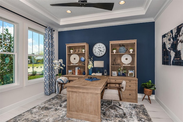 office featuring ceiling fan, a raised ceiling, and ornamental molding