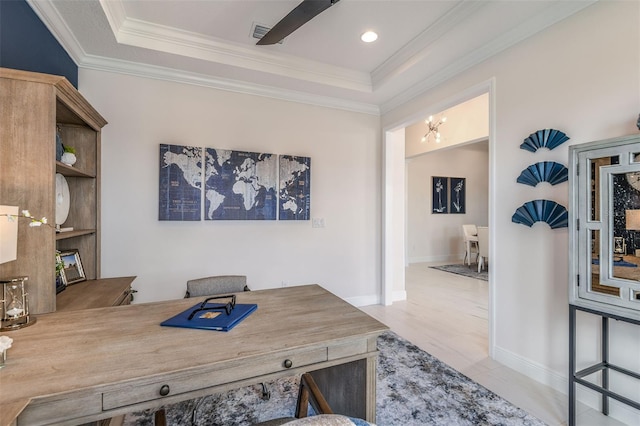 office with ceiling fan with notable chandelier, crown molding, and a tray ceiling