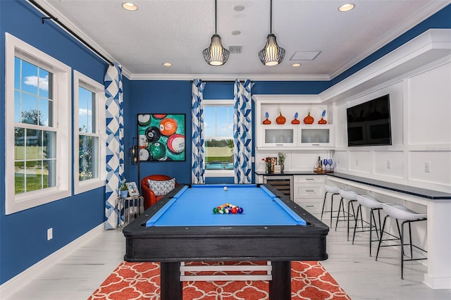 playroom with wine cooler, pool table, a textured ceiling, and ornamental molding