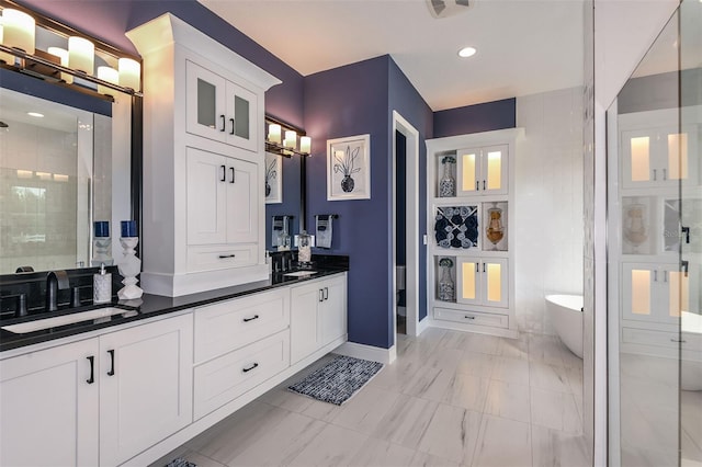 bathroom with vanity and shower with separate bathtub