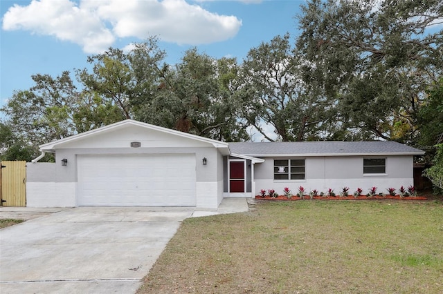 ranch-style home featuring a front yard and a garage