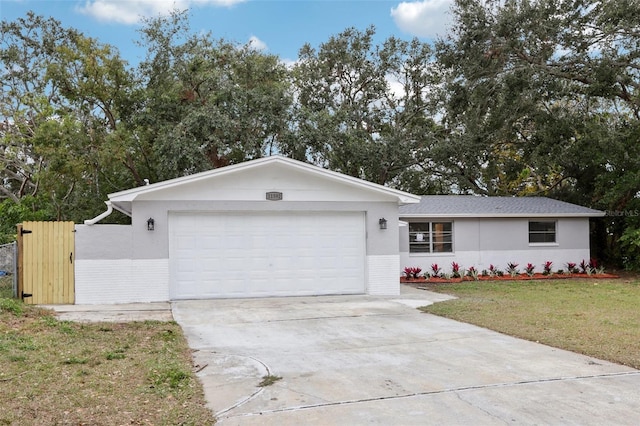 ranch-style home with a garage and a front yard