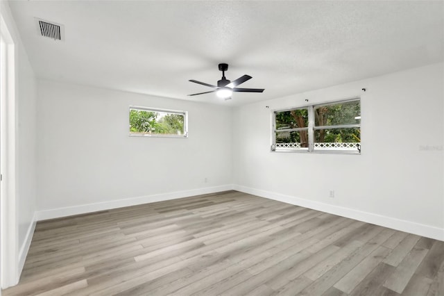 unfurnished room with ceiling fan and light hardwood / wood-style floors