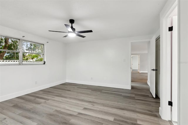 empty room featuring ceiling fan and light hardwood / wood-style flooring