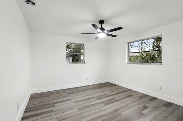 spare room with ceiling fan and hardwood / wood-style floors