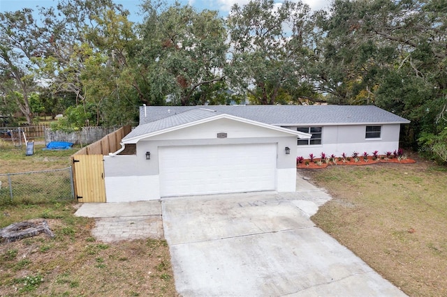 single story home with a front lawn and a garage