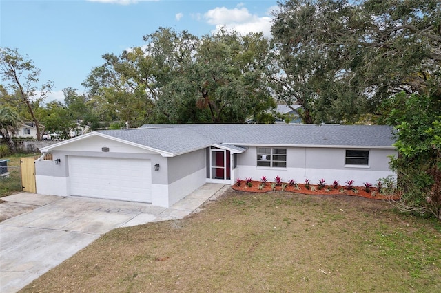 ranch-style house featuring a front yard and a garage